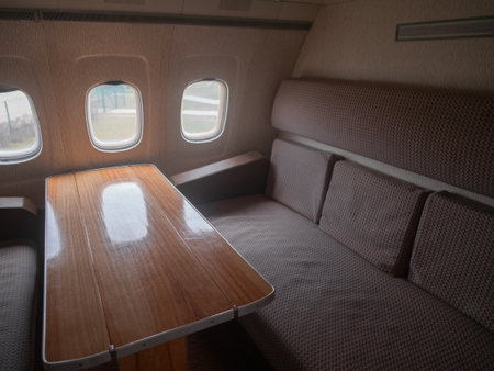 warmtoned wooden table between comfortable cushions, private dining area with warm wood and plush cushionsの写真素材