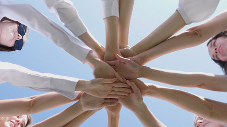 Working together as a team leads to collaboration and enhanced achievements under a clear sky