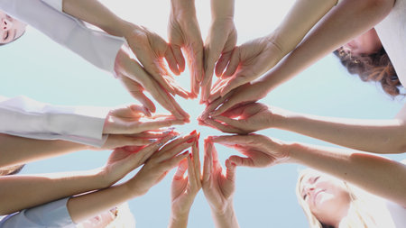 Hands United in Harmony Under a Beautiful Blue Sky, Celebrating Diversity and Connection