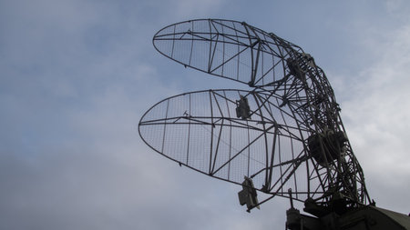 restoring and evaluating traditional parabolic radar apparatus against subdued sky backgroundの写真素材