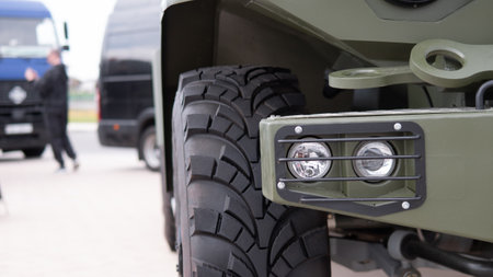 Military Vehicle Preparation With Off-Road Tires and Headlights in a Conflict Zone During Daylightの写真素材