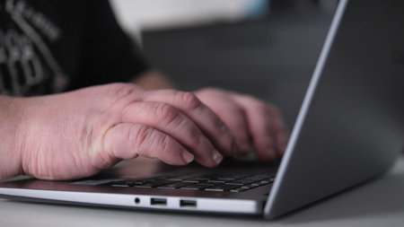 Closeup Hands On Laptop Keys, Analyst Reviewing Spreadsheets And Reports, Dim Ambient Light, Focused Data Entry And Review For Business Decisions And Remote Reportingの写真素材