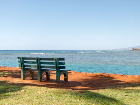 Lonely Park Bench on Waikiki Beachの写真素材