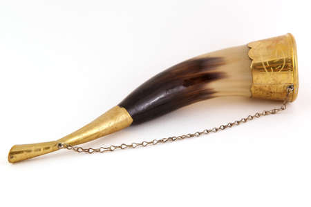 Drinking horn isolated on white background with brass accentsの写真素材