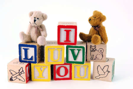 Bears sitting on toy blocks spelling Iの写真素材
