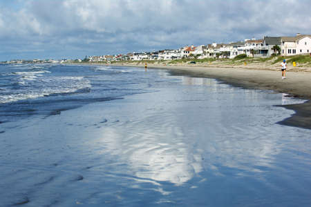 Charleston beach with sky reflected in the wet sandの写真素材