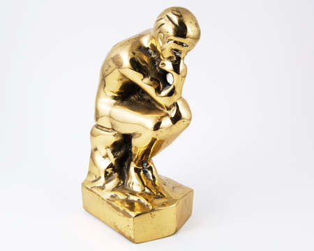 Thinking man in brass isolated on a white backgroundの写真素材