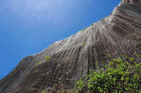 Maui coastline with rock retaining wall to protect carsの写真素材