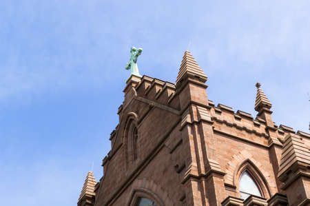 Red brick church highlighted by sunlight and blue skies in charleston scの写真素材