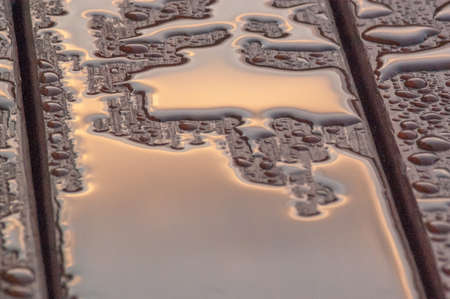 Pooled water on finished deck with woodgrain. Excellent background for illustrating construction or resilience.の写真素材