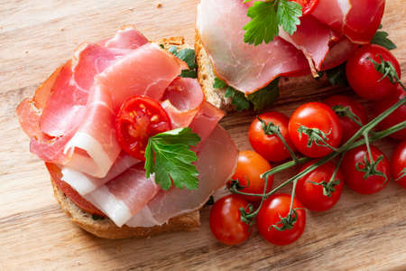 Sandwiches with Prosciutto, tomatoes and parsleyの写真素材