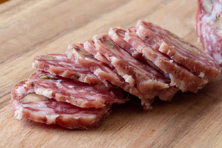 Sliced Air-dried salami - wood background