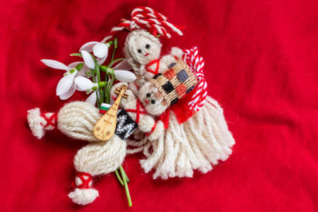 Martenitsa - traditional Bulgarian custom - red background with snowdropsの写真素材