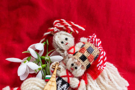 Martenitsa - traditional Bulgarian custom - red background with snowdrops