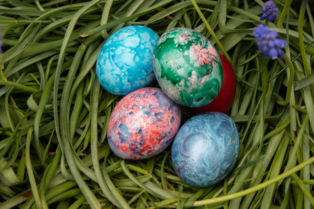 Colored easter eggs on green grass. Easter holiday concept.