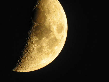 bright moon close up shot with visible lunar crater in dark nightの写真素材