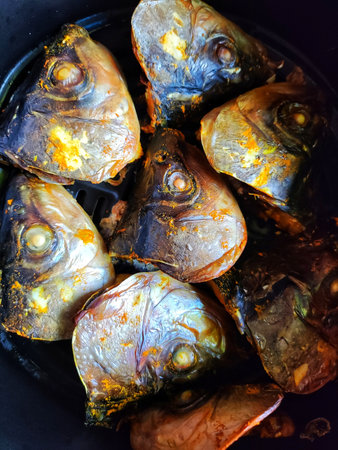Fried mackerel fish in a bowl. Close up.