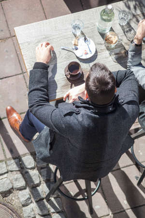 People drinking coffee in a street barの写真素材