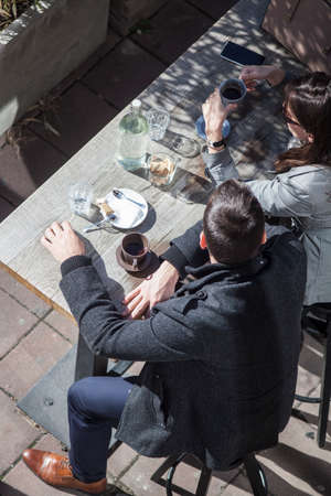 People drinking coffee in a street barの写真素材
