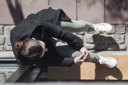 A girl resting in the street bar window waiting for coffeeの写真素材