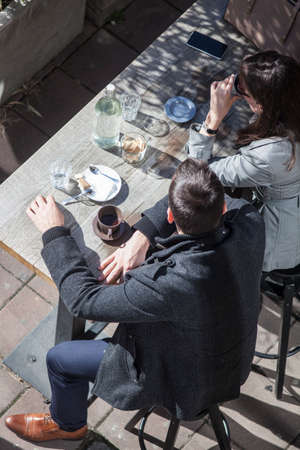 People drinking coffee in a street barの写真素材
