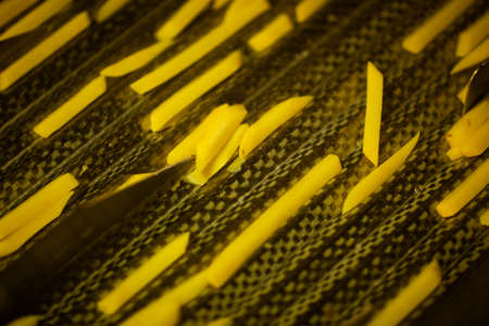Production line of a potato factory. French fries - fast food.の写真素材