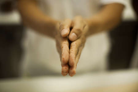 Human Hand sprinkling black pepper on pasta - making Raw and dry pasta on kitchen table -の写真素材