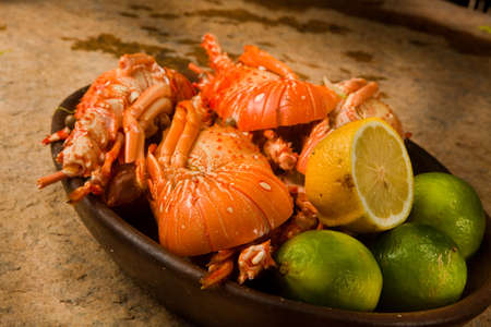 Delicious fresh and cooked whole lobster with lime, lemon on a banana leaf. high quality photoの写真素材