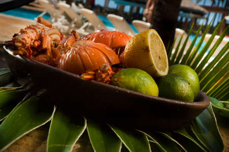 Delicious fresh and cooked whole lobster with lime, lemon on a banana leaf. high quality photoの写真素材