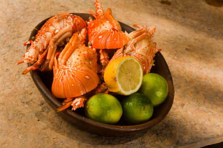 Delicious fresh and cooked whole lobster with lime, lemon on a banana leaf. high quality photoの写真素材