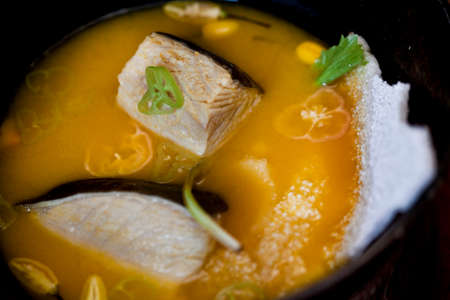 Amazonian cuisine. Green ingredients, manioc soup on a wooden table set. high quality photoの写真素材