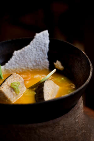Amazonian cuisine. Green ingredients, manioc soup on a wooden table set. high quality photoの写真素材