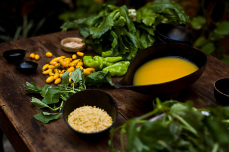 Amazonian cuisine. Green ingredients, manioc soup on a wooden table set. high quality photoの写真素材