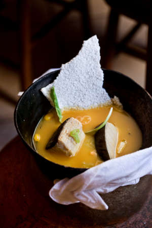 Amazonian cuisine. Green ingredients, manioc soup on a wooden table set. high quality photoの写真素材