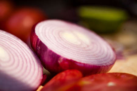 Tomatoes and onions on a kitchen cooking boards. Food background. high quality photoの写真素材