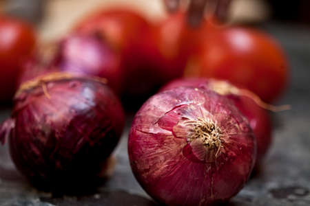 Tomatoes and onions on a kitchen cooking boards. Food background. high quality photoの写真素材
