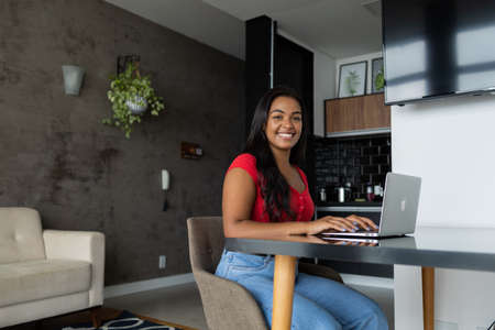 Young white man working at home with laptop on desk. Home office concept. Gray notebook for working. high quality photoの写真素材