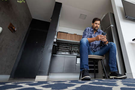 Young white man working at home with laptop on desk. Home office concept. Gray notebook for working. high quality photoの写真素材