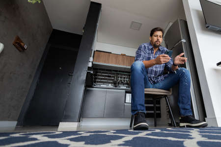 Young white man working at home with laptop on desk. Home office concept. Gray notebook for working. high quality photoの写真素材