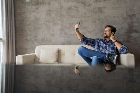 Young white man working at home with laptop on desk. Home office concept. Gray notebook for working. high quality photoの写真素材