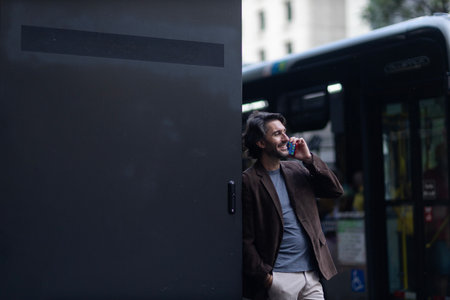 View of young man with smartphone at daytime with city view landscape in the background. High...