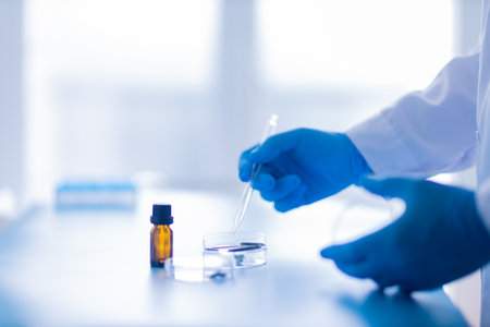 Production line pharmaceutical industry. Manufacturing of drugs and medications, pharmaceuticals. Laboratory gloves blue Petri dishの写真素材