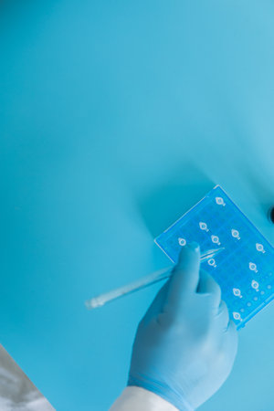 Production line pharmaceutical industry. Manufacturing of drugs and medications, pharmaceuticals. Laboratory gloves blueの写真素材