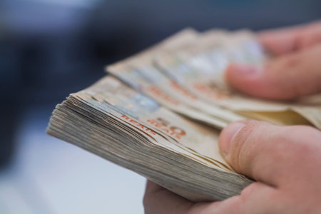 Human hand of businessman working in exchange office/bank. He is counting money and giving cash...