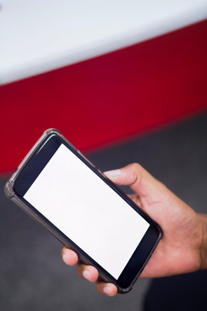 Hand of business people holding smartphone - mobile phone.の写真素材