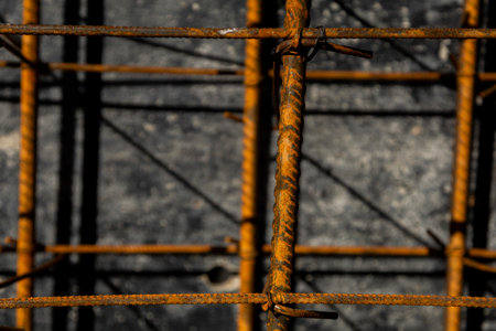 Close-up of rusted steel rebar used in reinforced concrete construction. The image shows the texture and structure of building materials on-site.の写真素材