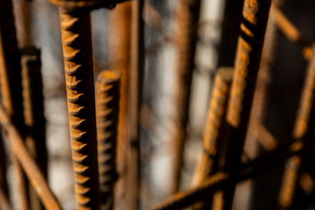 Close-up of rusted steel rebar used in reinforced concrete construction. The image shows the texture...