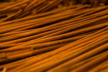 Thin wooden sticks organized on a workbench for handcrafted production.の写真素材