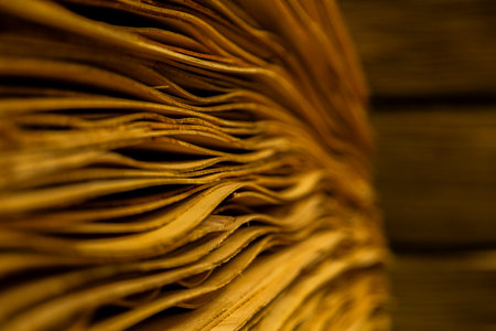 Close-up of thin wood veneer sheets stored in warehouse for manufacturing and industrial use.の写真素材
