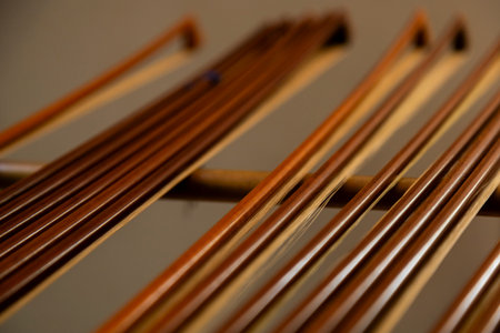 Thin wooden sticks organized on a workbench for handcrafted production.の写真素材